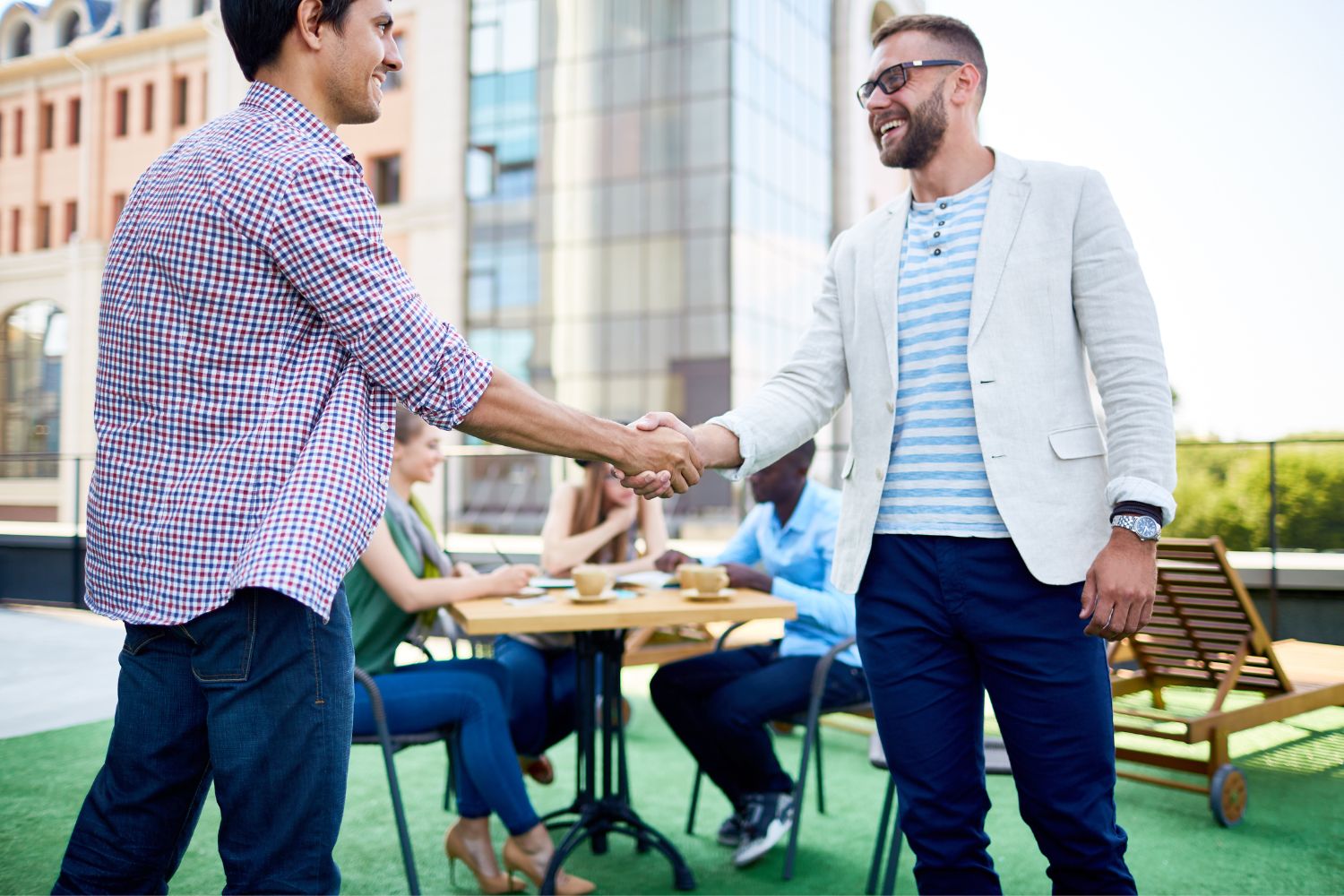 two men shaking hands greeting eachother